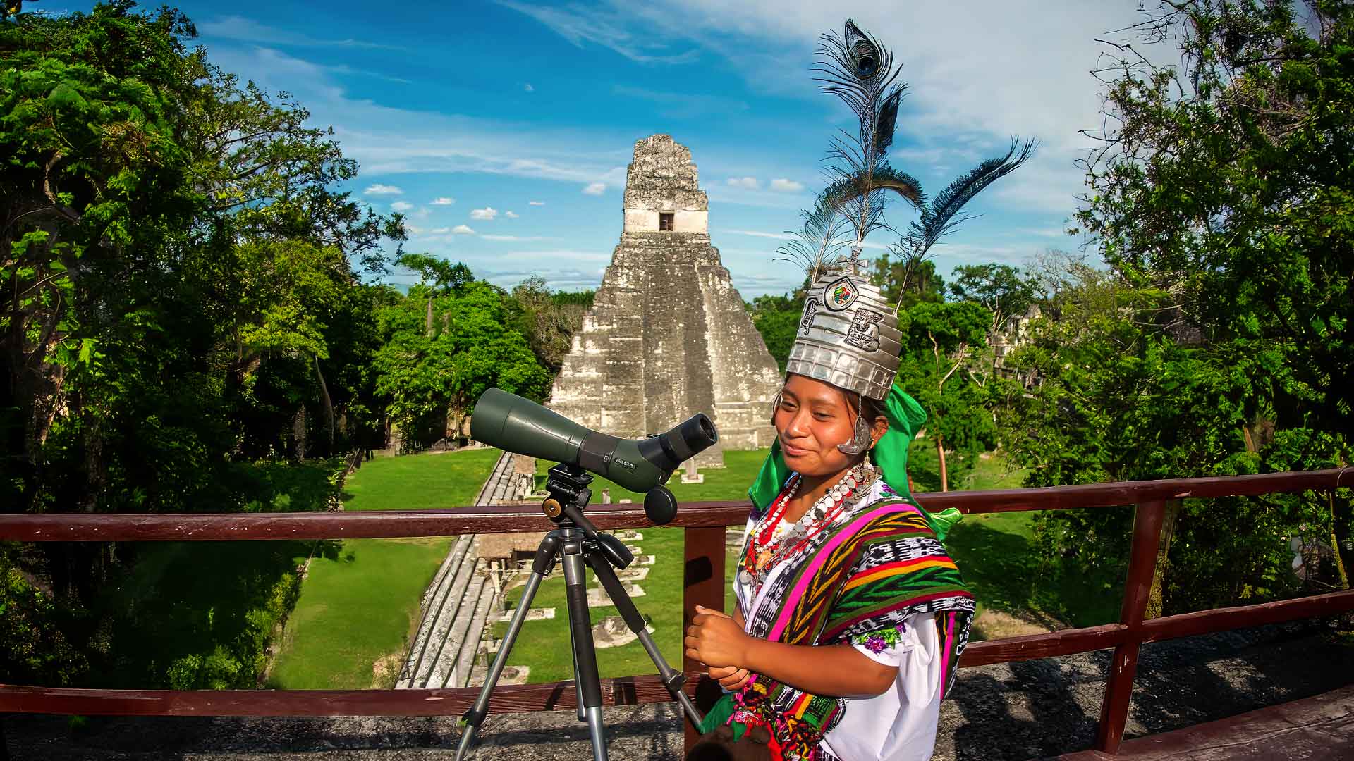 Guatemala-ancient-ruins-maya-legacy: the picture perfectly combine the past and present of the Maya. A Maya queen and Tikal temple in the background.