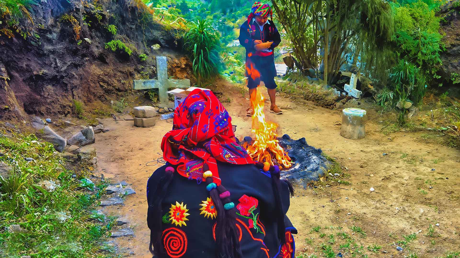 Guatemala Maya Shamanic Ceremonies: "Two Maya priests engaged in a Guatemala Maya Shamanic Ceremony at a sacred shrine, seated opposite each other with a firelight altar between them, wearing vibrant ceremonial attire."