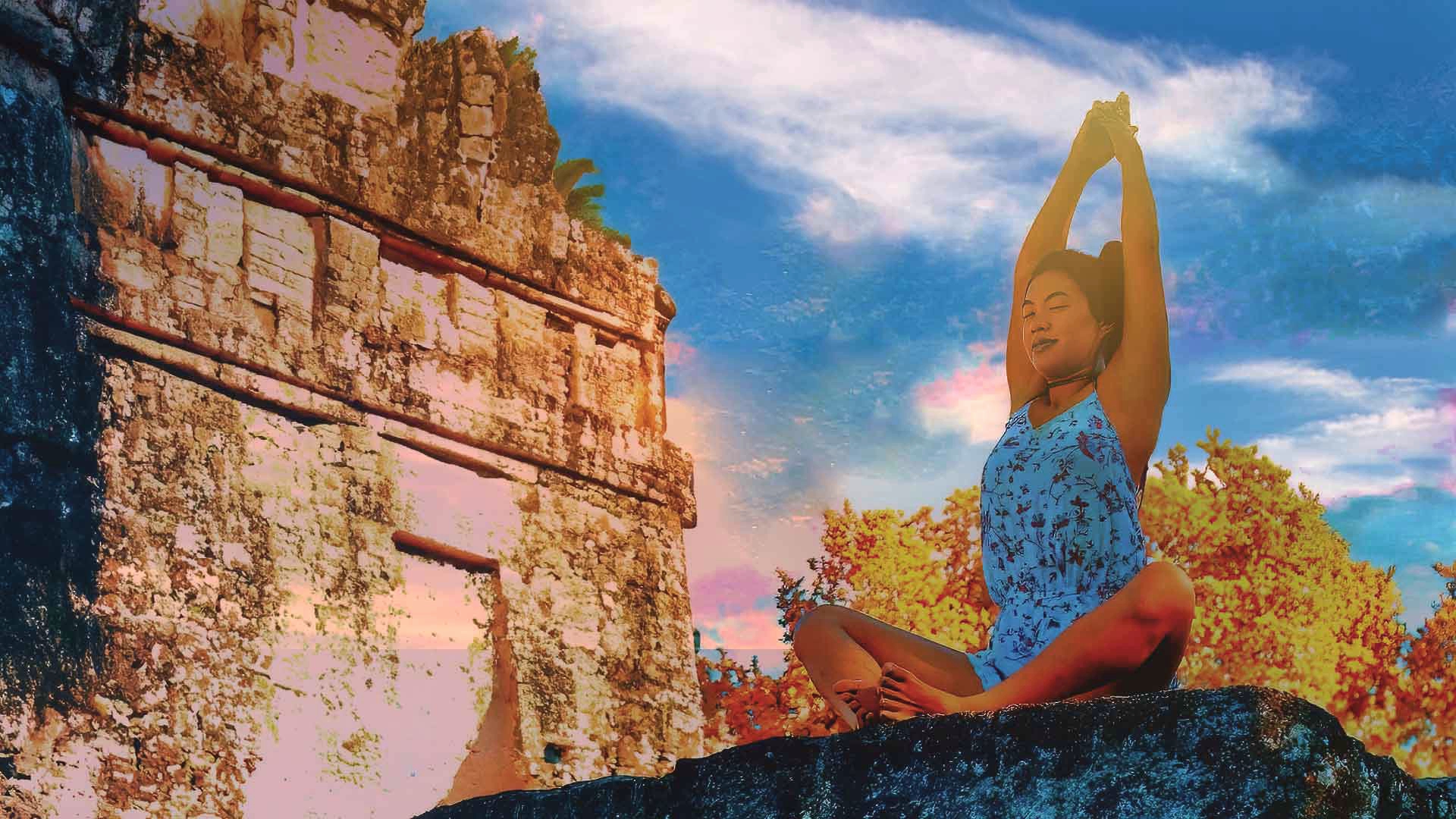 Wellness Travel Guatemala: A young girl seated on top of a Tikal pyramyd during a Yoga session.