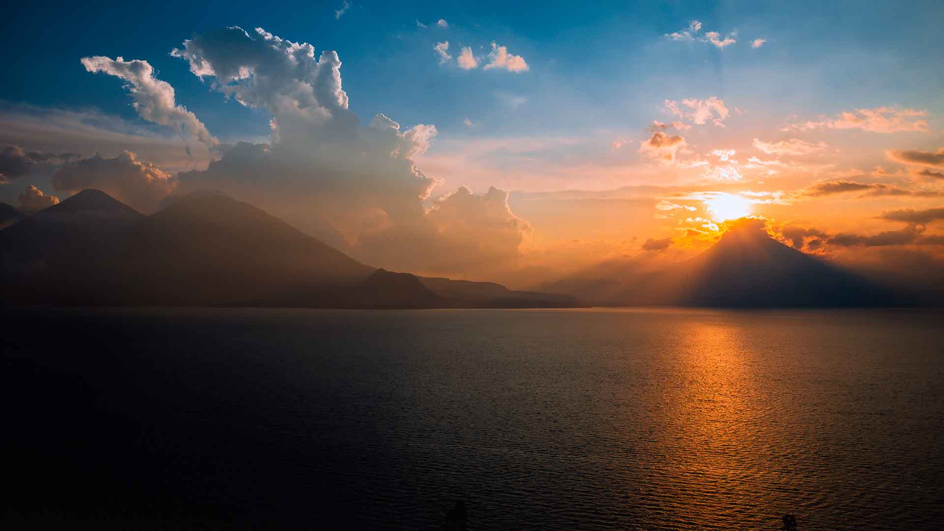 Stunning sunset at Lake Atitlán, illustrating the beauty of Guatemala while considering the question: Is it safe to travel to Guatemala?