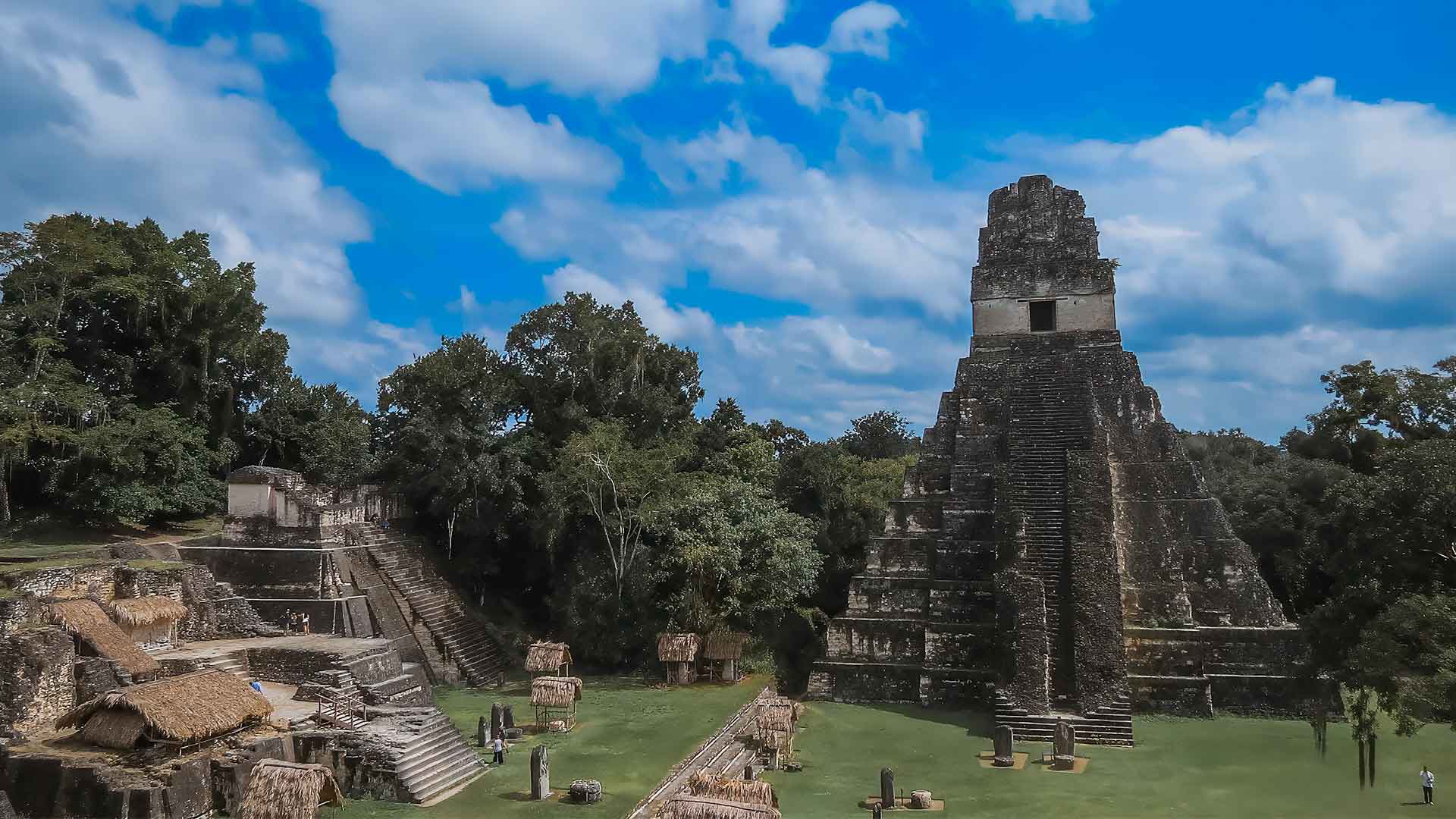 Is it safe to travel to Guatemala? View of Tikal's main plaza featuring the iconic Great Jaguar Temple, a popular and safe tourist destination.