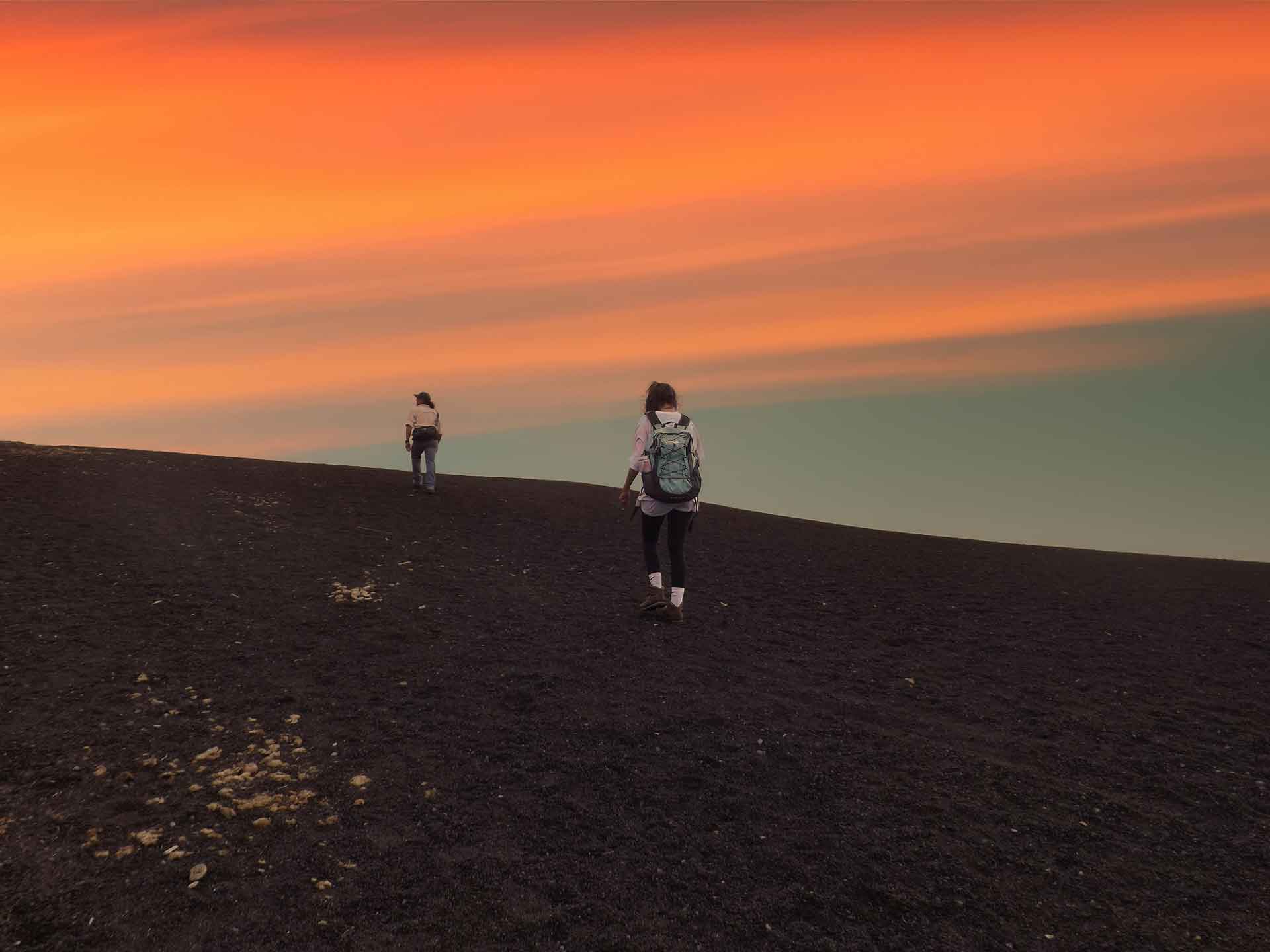 Adventurers reaching the peak of Pacaya volcano during the sunset as a part of the Guatemala Hiking Trails