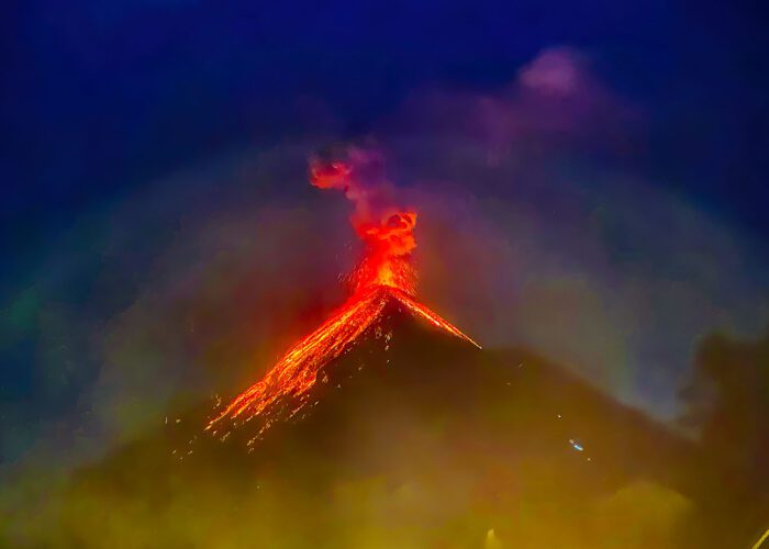 Acatenango Volcano Tour - Nocturnal view of Fuego Volcano erupting, seen from Acatenango Volcano, showcasing spectacular bursts of radiant magma, during the Volcano Hiking Trail in Guatemala.