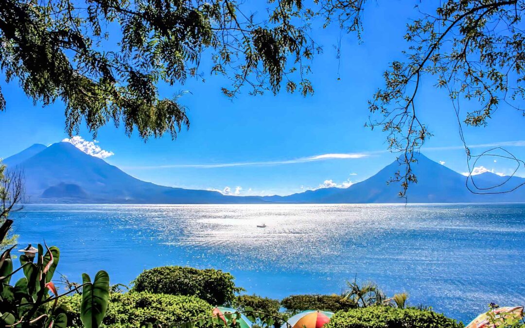 This photograph showcases Lake Atitlan's beauty framed with majestic volcanoes in our Guatemala Cultural Holiday.