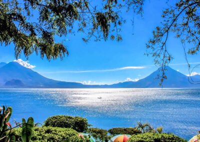 This photograph showcases Lake Atitlan's beauty framed with majestic volcanoes in our Guatemala Cultural Holiday.