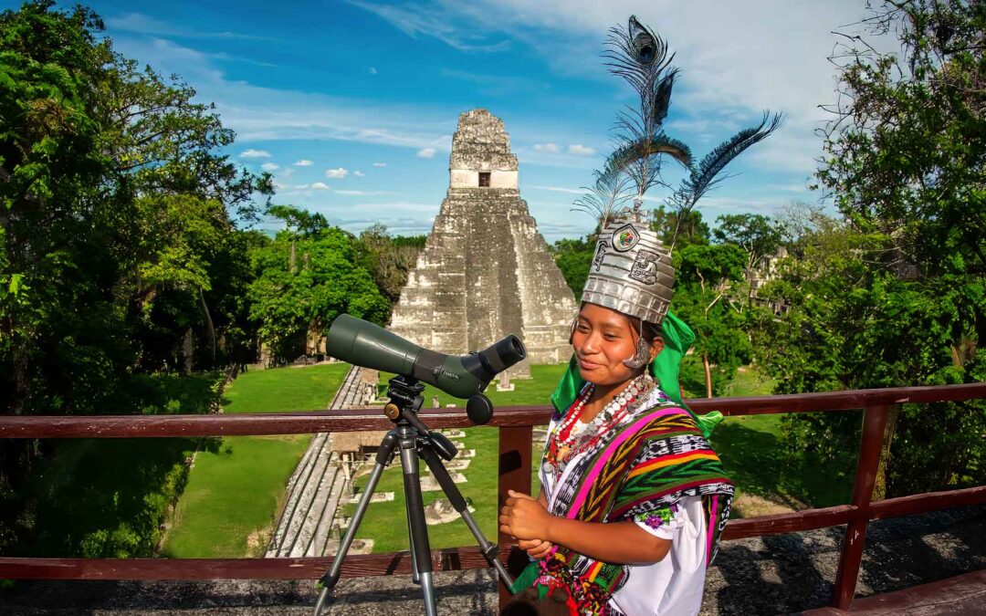 Guatemala-ancient-ruins-maya-legacy: the picture perfectly combine the past and present of the Maya. A Maya queen and Tikal temple in the background.